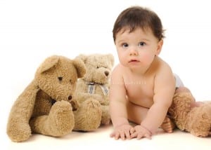 baby with teddy bears in high-key lighting