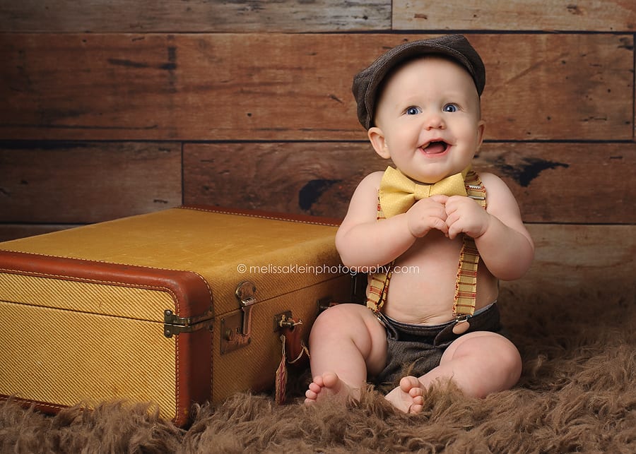 baby with bowtie and vintage suitcase
