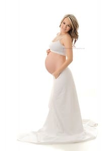 high key maternity photo in studio with white gown
