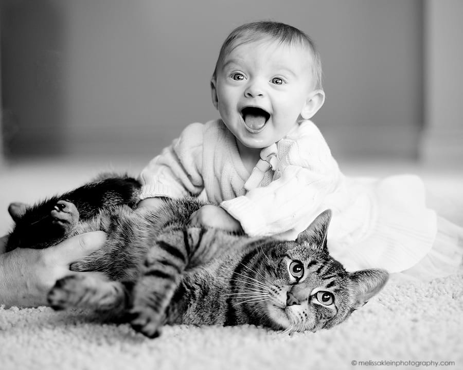 baby girl with her cat and big smile
