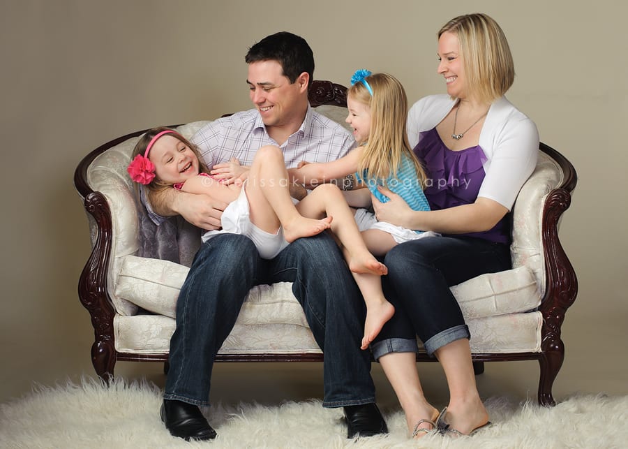 family sitting on antique settee