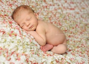 newborn girl on flower fabric