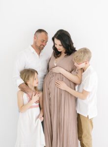 maternity photos with family of four in studio