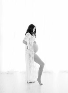 black and white backlit maternity photos in lace robe