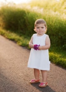 girl in dress holding flower