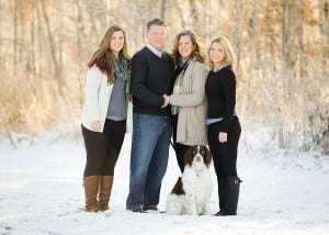 family photo outdoors in winter snow with dog