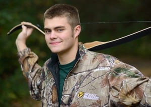 outdoor senior photo of boy with hunting bow