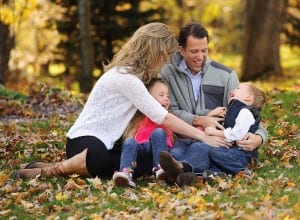 fall family photo playing in the leaves