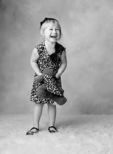 girl with teddy bear laughing