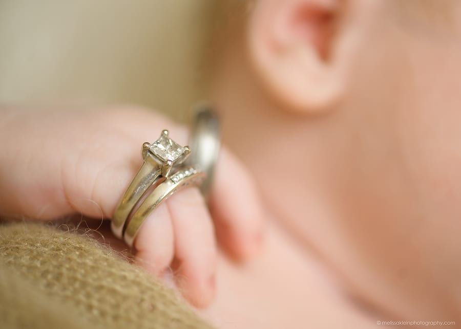 macro photo of baby with wedding rings