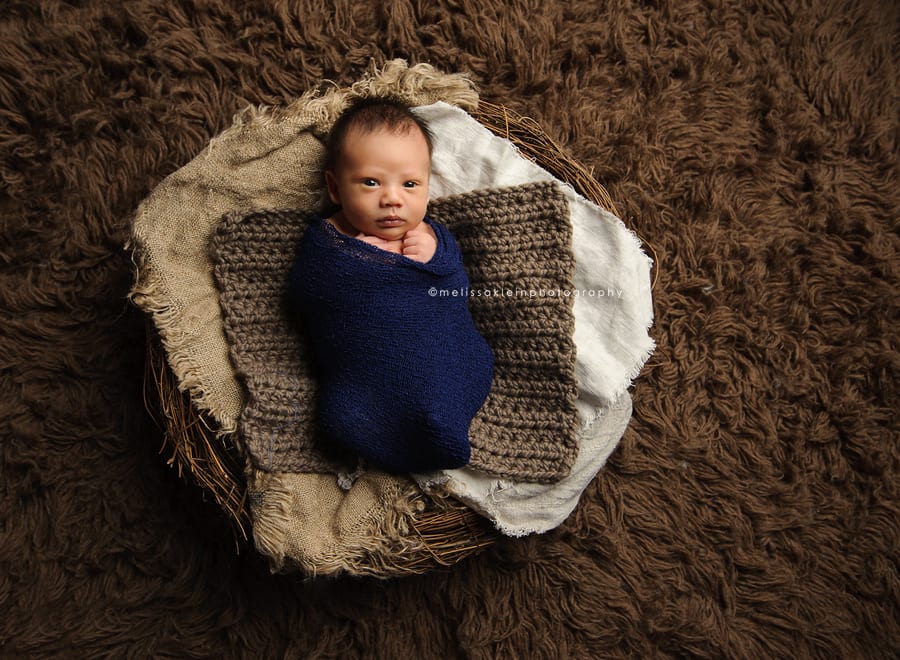 newborn baby boy on fuzzy rug