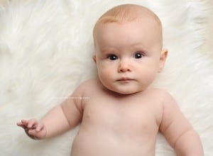 six month baby girl on fur rug