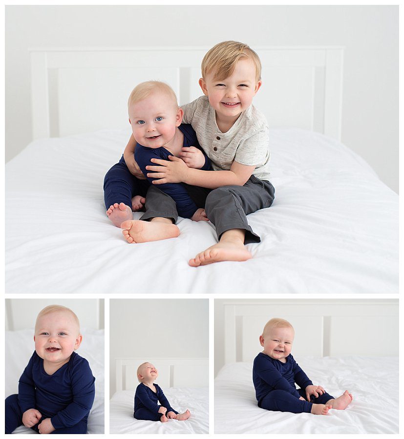 1 and 3 year old siblings in studio for photos on white bed
