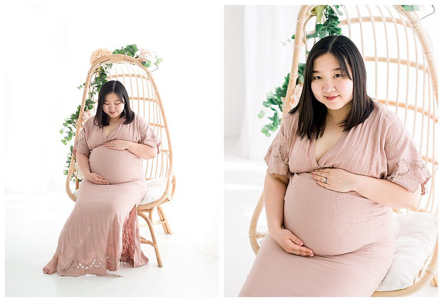 maternity photos with mom in pink dress, sitting in wicker chair with flowers