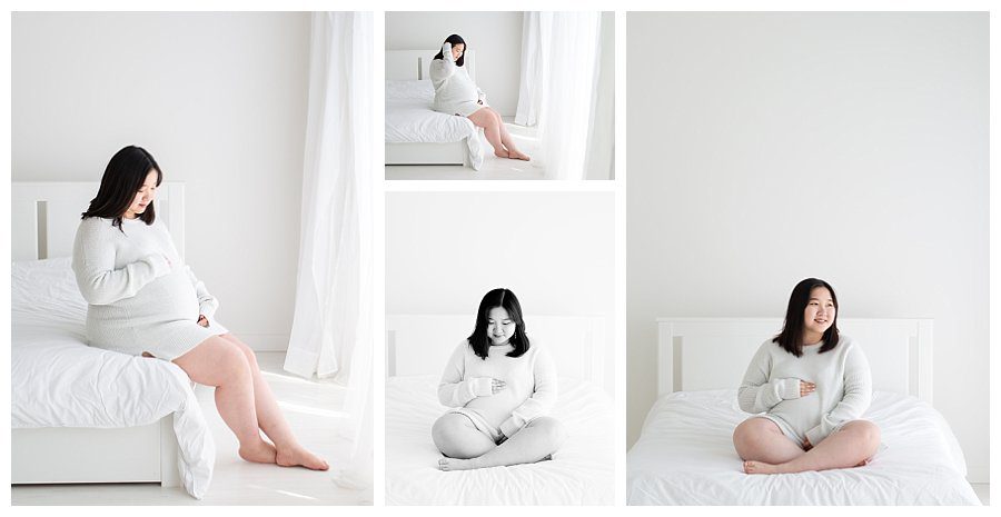 pregnant mom sitting on white bed in natural light photography studio