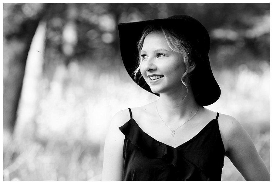 black and white photo of girl with hat