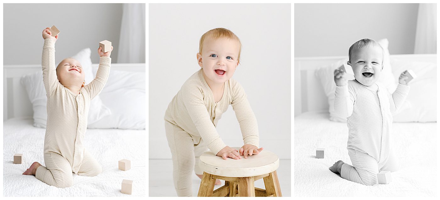 1 year old baby boy playing with blocks on a bed 