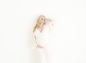Surrogacy photographer in Minneapolis photographs maternity portraits in a natural light studio