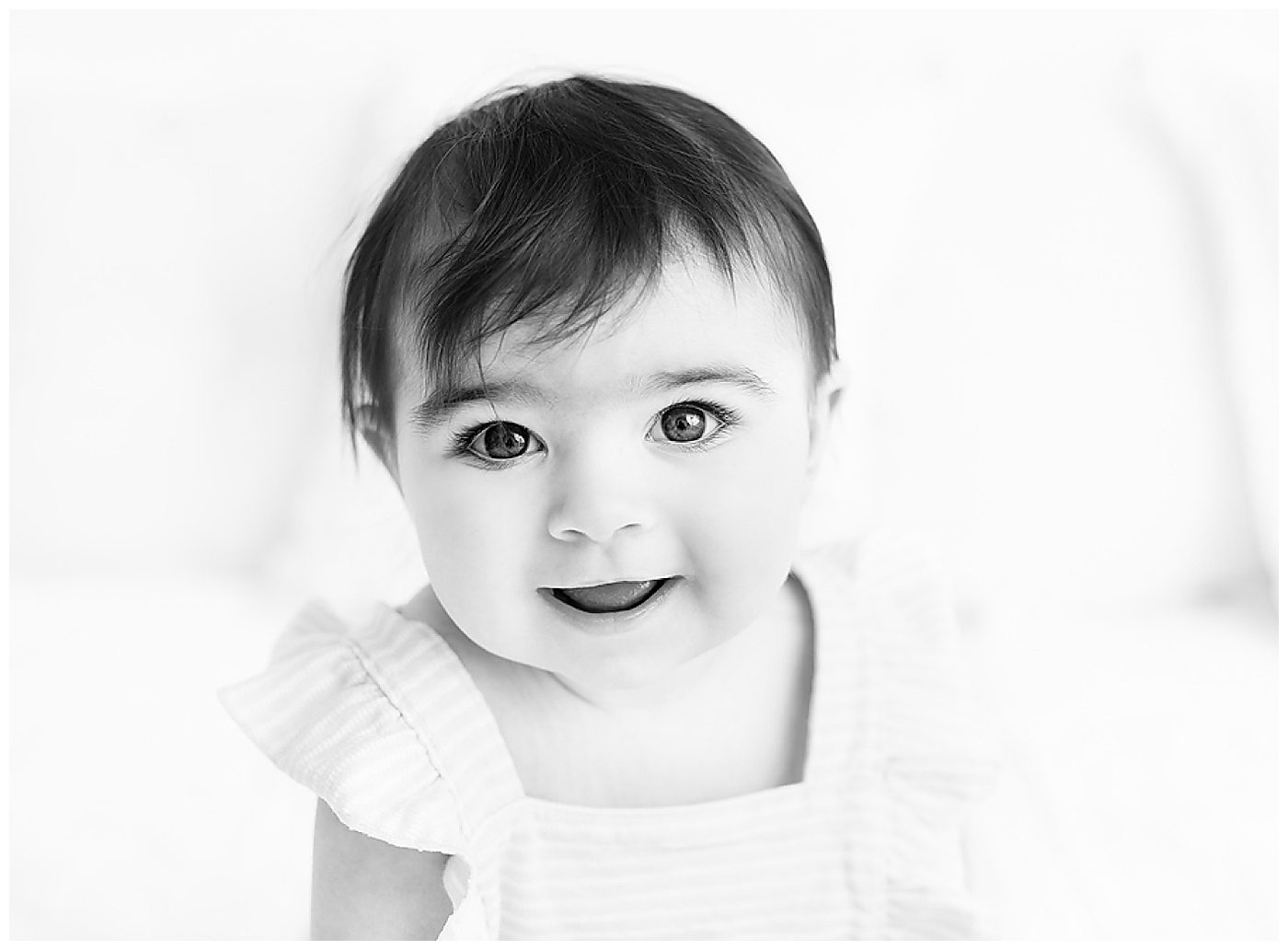 black and white photo of 7.5 month old baby girl with beautiful eyes