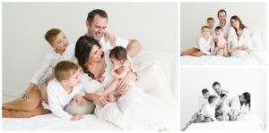 Family photos on white bed with 7 month old baby girl and her two older brothers