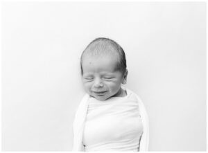smiling newborn baby boy in natural light photography studio in Blaine MN