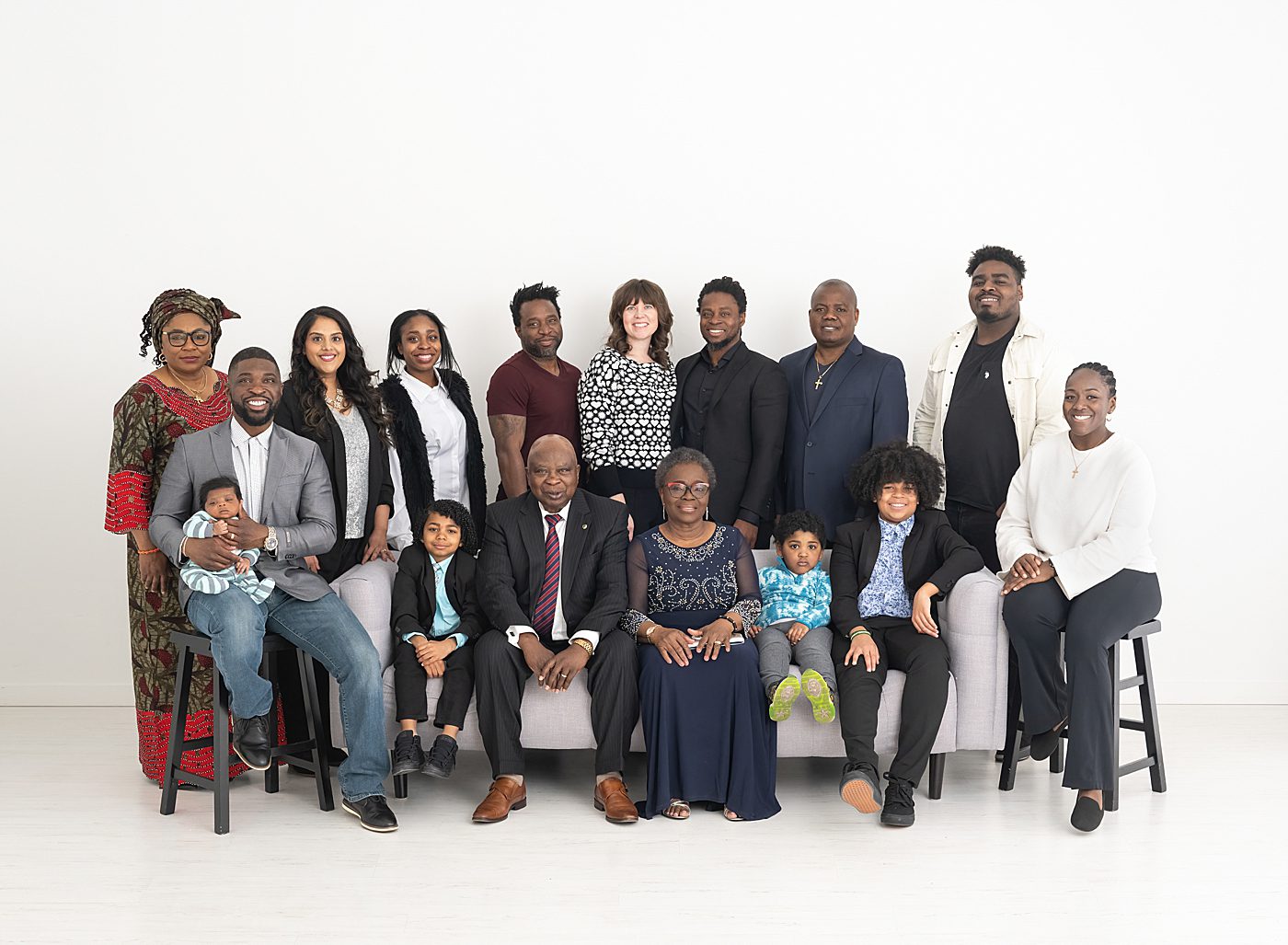 extended family photos with a group of 16 on white backdrop