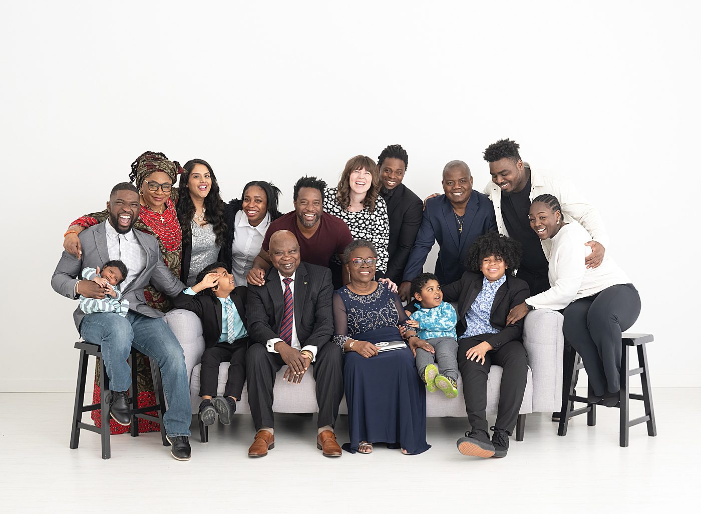 extended family photos with a group of 16 on white backdrop in Minneapolis