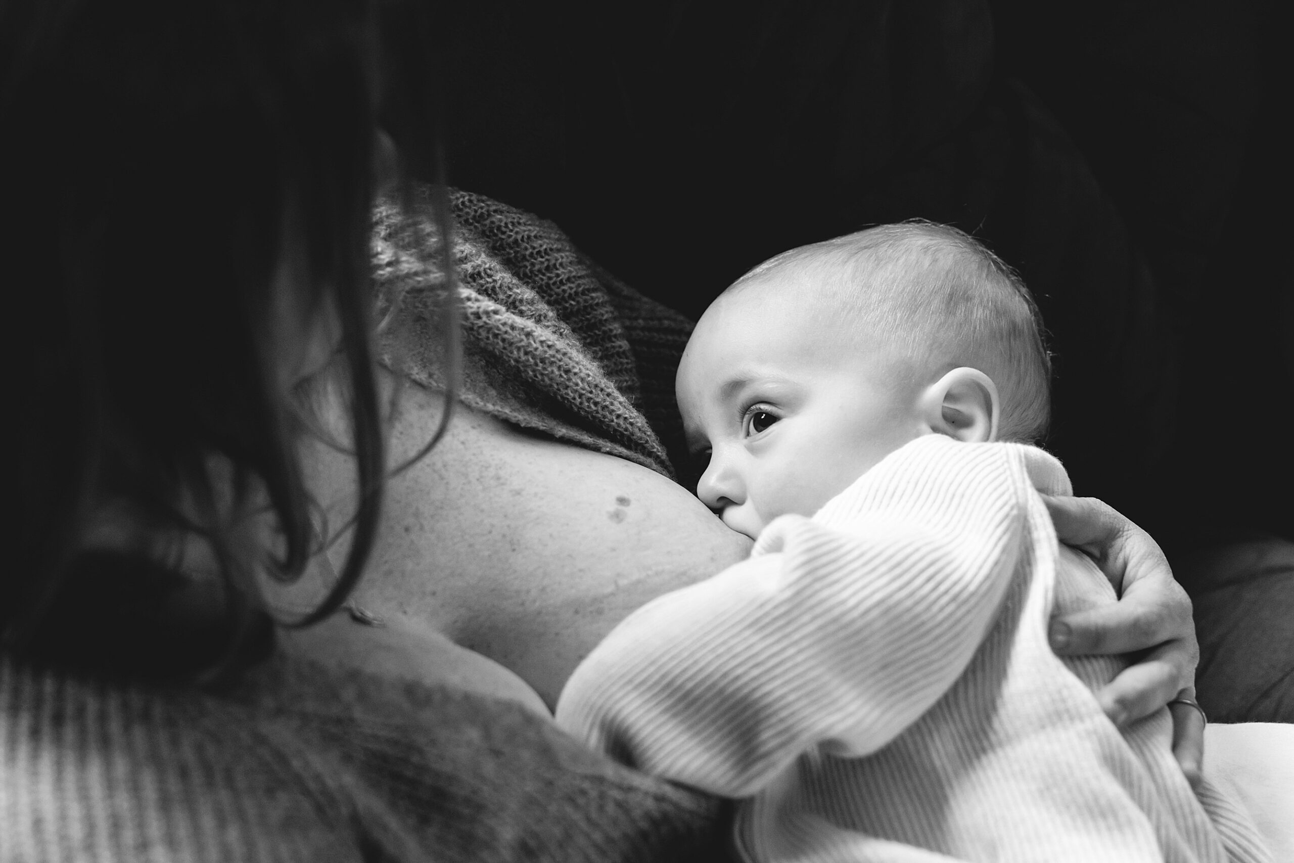 black and white photo of mom feeding baby