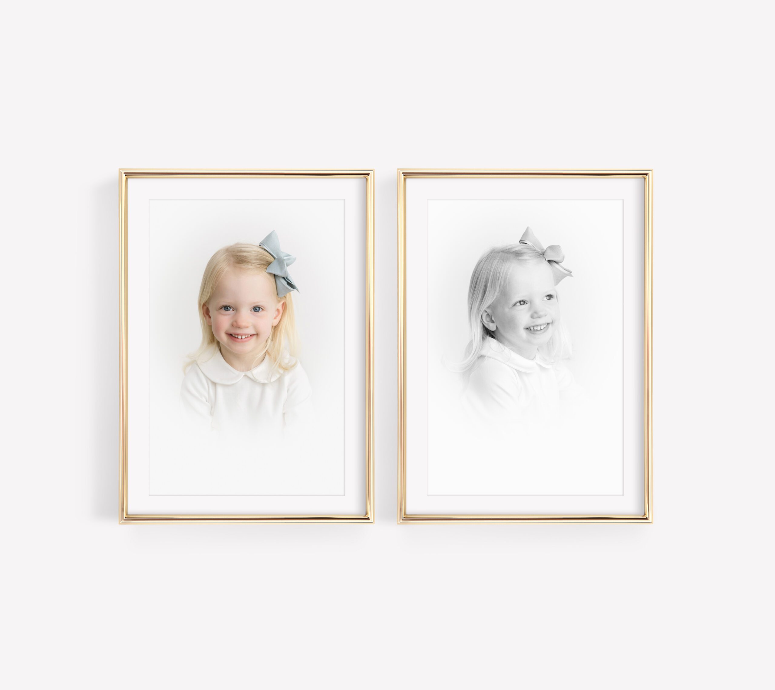 two framed heirloom portraits of toddler girl with white collared shirt and blue hair ribbon. photos have a white vignette