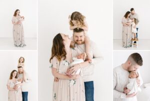 family photos with toddler sister and newborn with family standing in natural light white photography studio in Blaine